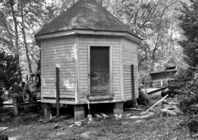 The octagon building sits on its new foundation at the back of the rear lawn.